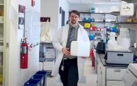 a scientist wearing lab coat standing in a research laboratory
